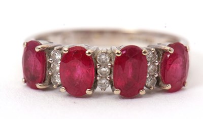 Lot 58 - An 18ct ruby and diamond ring, the four oval...