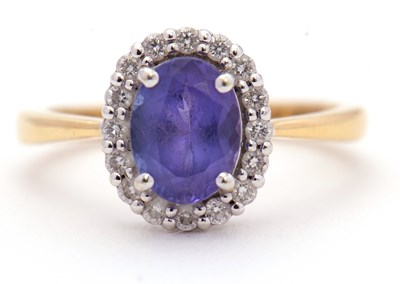 Lot 47 - An 18ct tanzanite and diamond ring, the oval...