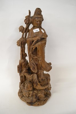 Lot 283 - Large carved wooden model of Guanyin holding a...