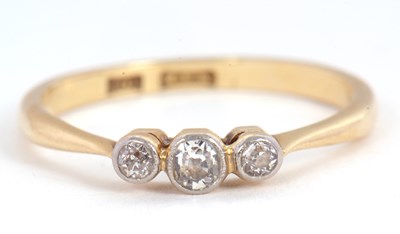 Lot 22 - An 18ct three stone diamond ring, the three...