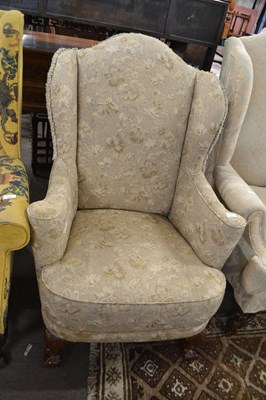 Lot 534 - A Georgian style wing back armchair with short...