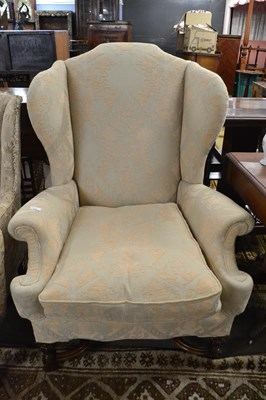 Lot 535 - A large Georgian style wing back armchair with...