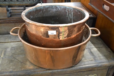 Lot 558 - A large circular copper double handled pan...