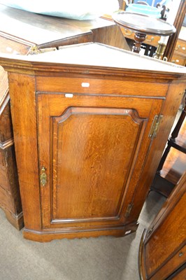 Lot 602 - A George III oak corner cabinet with moulded...