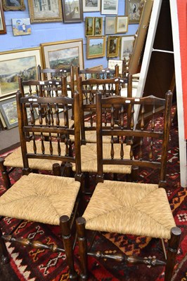 Lot 657 - A set of six spindle back and rush seated...