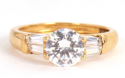 Lot 37 - An 18ct CZ ring, the round CZ set with two...