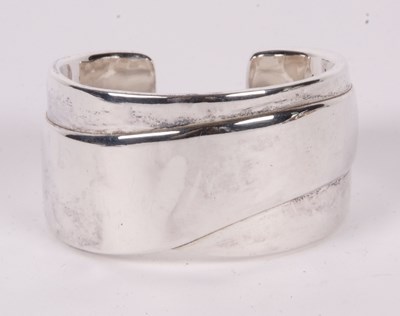 Lot 239 - A contemporary silver cuff bracelet, the...