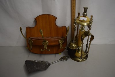 Lot 142 - A coat hook and a fire companion set