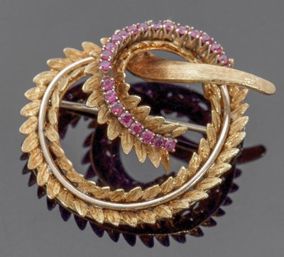 Lot 182 - 18ct gold and ruby set brooch, an entwined...
