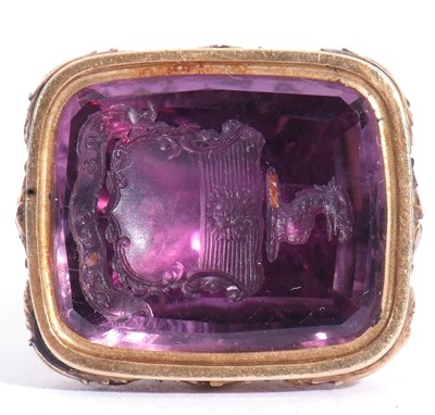 Lot 209 - Antique gold and amethyst fob, the carved fob...