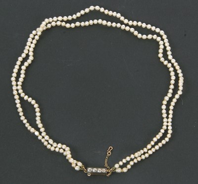 Lot 269 - A two strand 'pearl' choker with diamond clasp,...