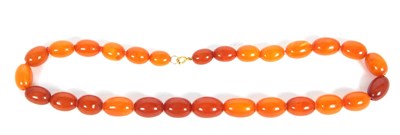 Lot 249 - An amber bead necklace, the oval graduated...