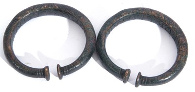 Lot 243 - Pair of bronzed metal torc bracelets with...