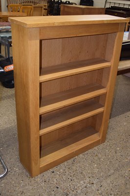 Lot 274 - A modern light oak bookcase cabinet