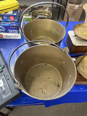 Lot 557 - Two brass jam pans and a further small brass...