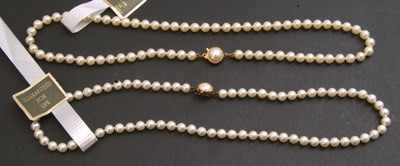 Lot 319 - Two cased strings of simulated pearls, both...
