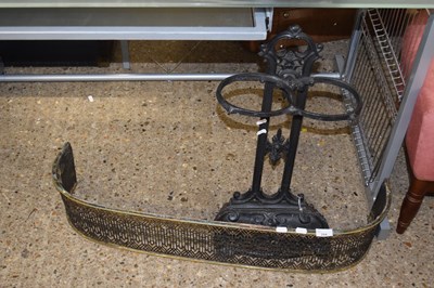 Lot 294 - Brass fire kerb and a cast iron stick stand (2)