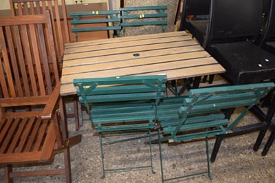 Lot 320 - A slatted hardwood garden table and four chairs