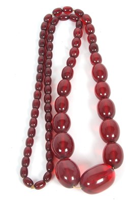 Lot 287 - A bakelite 'cherry amber' bead necklace, the...