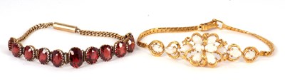 Lot 233 - A garnet bracelet, comprised of eleven oval...