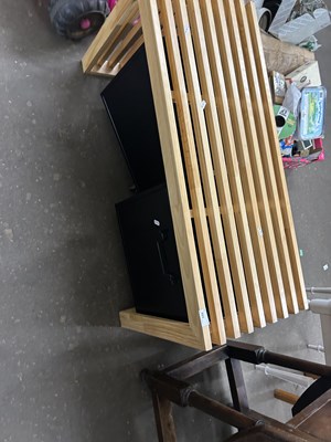Lot 693 - A slatted bench with two storage boxes beneath