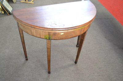 Lot 556 - A George III mahogany demi lune card table of...