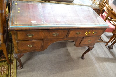 Lot 566 - A Georgian style walnut desk with tooled...