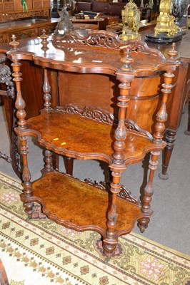 Lot 571 - A Victorian walnut three tier what not with...