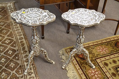 Lot 610 - A pair of small Syrian inlaid lamp tables with...