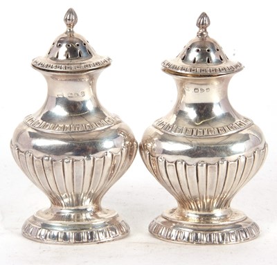 Lot 68 - A pair of early 20th Century silver peppers of...