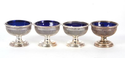 Lot 71 - A set of four George V silver pedestal salts...