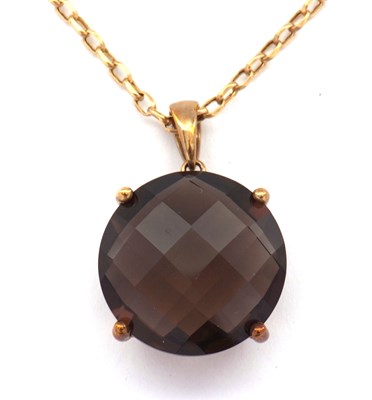 Lot 121 - A 9ct smokey quartz pendant, the round faceted...