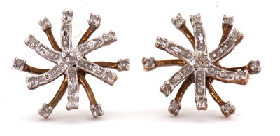 Lot 82 - A pair of 9ct diamond earrings, the starburst...