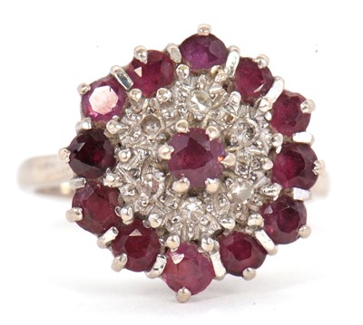 Lot 47 - A garnet and diamond ring, set with a central...