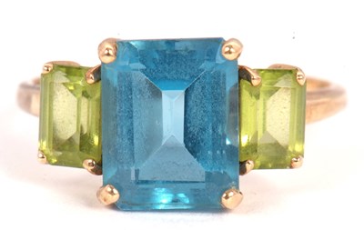 Lot 51 - A topaz and peridot ring, the central emerald...