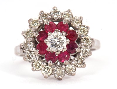 Lot 48 - A ruby and diamond cluster ring, the central...