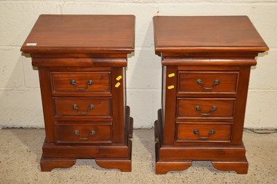 Lot 360 - A pair of modern hardwood three drawer bedside...