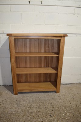 Lot 375 - A modern oak open front bookcase cabinet