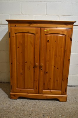 Lot 379 - A small pine two door wardrobe with internal...