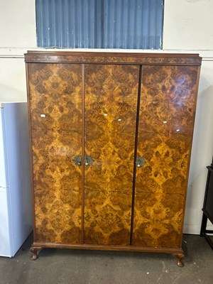 Lot 642 - Early 20th Century walnut veneered triple door...