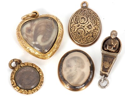 Lot 150 - A small group of charms: to include a heart...