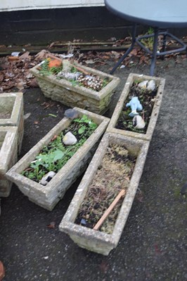 Lot 790 - Four composite garden planters modelled as...