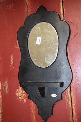 Lot 336 - A black painted pine wall mirror and shelf