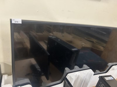 Lot 676 - A large flat screen television