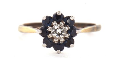 Lot 31 - A sapphire and diamond ring, the central round...