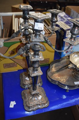 Lot 574 - A pair of electro plated three branch candelabra