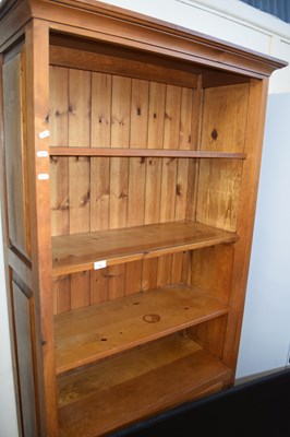 Lot 682 - A modern pine bookcase cabinet with cupboard base