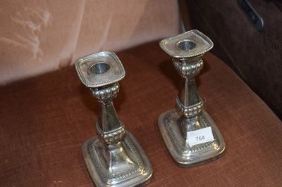 Lot 764 - A pair of electro plated candlesticks