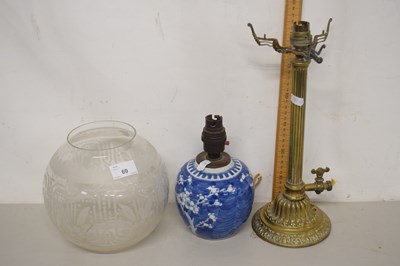 Lot 69 - A brass based table lamp with frosted glass...