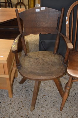 Lot 269 - An early 20th Century elm seated desk chair